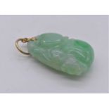 A Chinese celadon jade carving on pendant mount, 23mm (excluding mount)Length 23mm and 15mm at