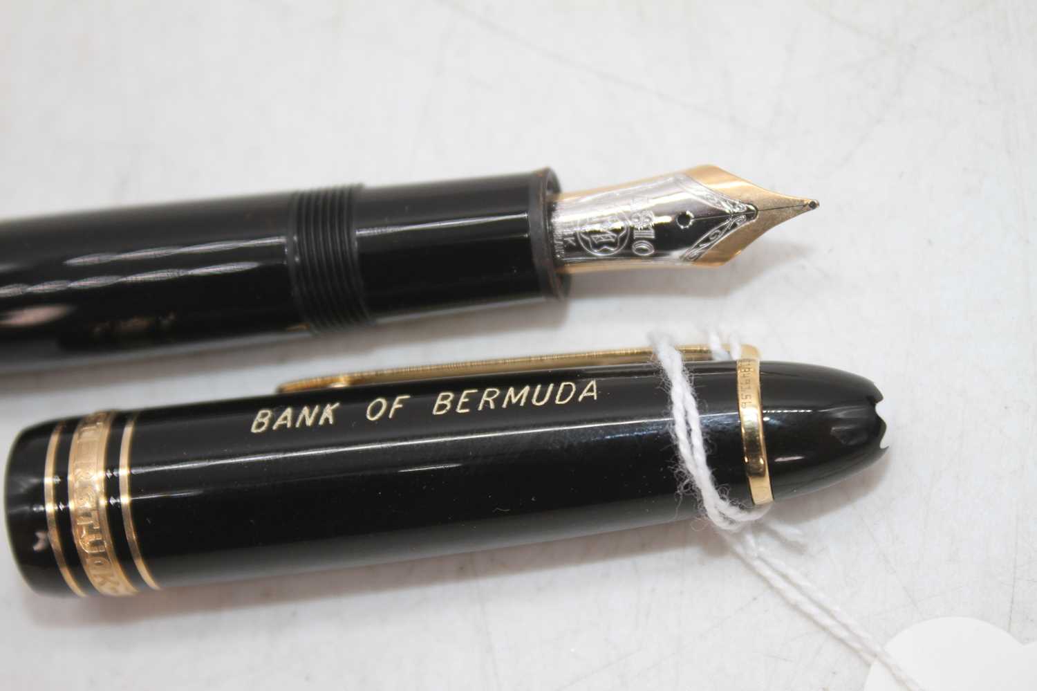 A Montblanc Meisterstuck 4810 fountain pen, in black with gold trim and snow-cap logo to to cap,