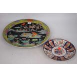 A 20th century Chinese famille noir charger, dia.37cm; together with a Japanese imari dish, dia.22cm
