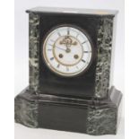 A Victorian black slate mantel clock, the enamelled chapter ring showing Roman numerals, the eight-