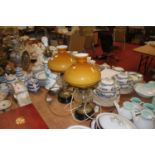 A pair of Victorian oil lamps, the amber glass shade above a faceted clear glass font, later