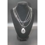 A contemporary white metal and cz set pendant, stamped 925, on finelink neck chain; together with