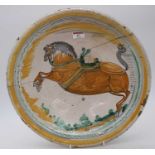 A tin glazed earthenware bowl, probably 17th century, polychrome decorated with a rearing horse,