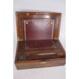 A Victorian walnut writing slope, the lid lifting to reveal a tooled burgundy leather writing