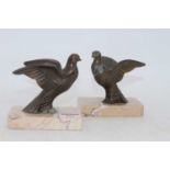 A pair of Art Deco bronzed models of doves, each mounted upon a polished hardstone plinth, h.11.5cm