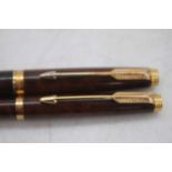 A Parker 75 Laque Thuya fountain pen and ballpoint pen set, with gold trim, the cap band marked