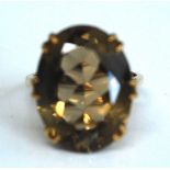 A 9ct yellow gold smoky quartz dress ring, the oval faceted smoky quartz measuring approx 20.15 x