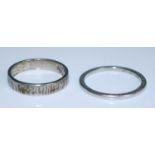 Two wedding bands, being an 18ct white gold 3.6mm straight edge band with bark finish, size K½,