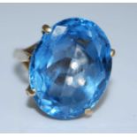 A 9ct gold blue topaz dress ring, the oval faceted blue topaz measuring approx 20.05 x 15.45 x 8.