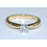 An 18ct yellow and white gold diamond single stone ring, comprising a round brilliant cut diamond in