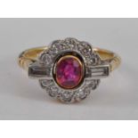 A yellow and white metal, ruby and diamond oval cluster ring, featuring a centre oval faceted ruby
