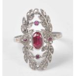 A white metal, synthetic ruby and diamond openwork panel ring, featuring a centre oval faceted