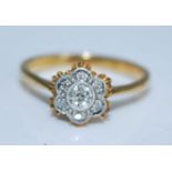 An 18ct yellow and white gold diamond circular cluster ring, comprising seven single cut diamonds
