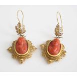 A pair of yellow metal carved coral cameo drop earrings, each featuring an 18 x 12mm oval cameo