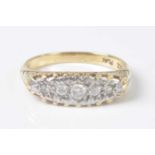 A yellow and white metal diamond five stone half hoop ring, featuring a graduated round brilliant