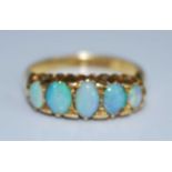 An 18ct yellow gold opal five stone half hoop eternity ring, comprising five graduated opal