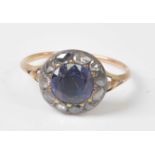 An early 19th century yellow and white metal, sapphire and diamond circular cluster ring, comprising
