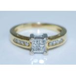 A yellow and white metal diamond quatrefoil cluster ring, featuring four princess cut diamonds