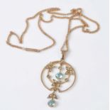 A rose and yellow metal Edwardian openwork zircon and seed pearl pendant, featuring two round
