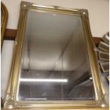 A reproduction gilt framed and bevelled rectangular wall mirror, 106x75cm