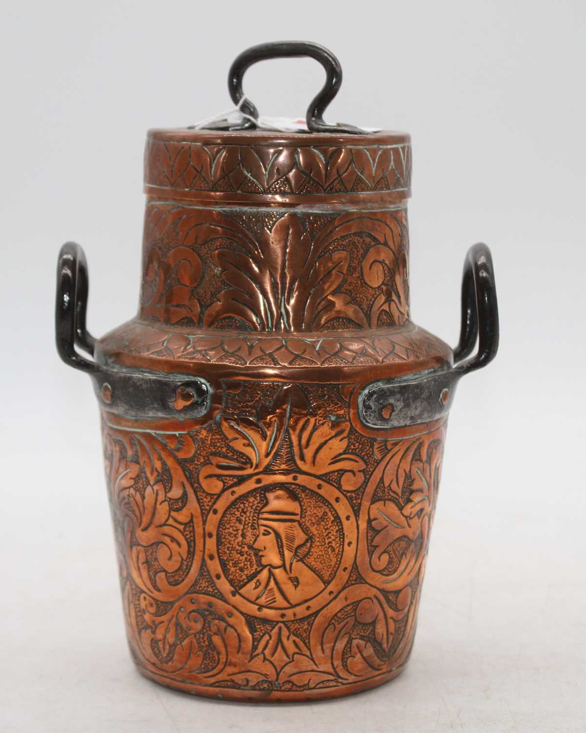 A late 19th century eastern copper container and cover having foliate engraved decoration with