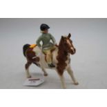 A Beswick model of a girl on a pony, model No.1499, h.14cm