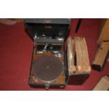 A vintage His Master's Voice portable record player; together with various vintage records