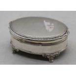 A George VI silver trinket box, of oval form, having a hinged engine turned cover with vacant