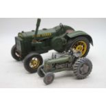 A reproduction metal model fo a John Deere tractor, 32cm; together with one other smaller (2)