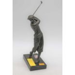 A modern bronze figure of a golfer, mounted upon a polished black hardstone plinth, h.30cm