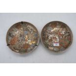 A pair of Japanese satsuma shallow dishes, each typically decorated with various figures within