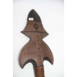 A hardwood paddle, the shaped blade with incised geometric decoration with further incised handle,