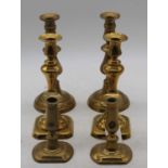 A pair of mid 19th century turned brass candlesticks with ejectors, height 24cm, together with two