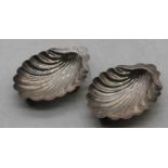 A pair of Edwardian silver shell shaped butter dishes, 2.7oz