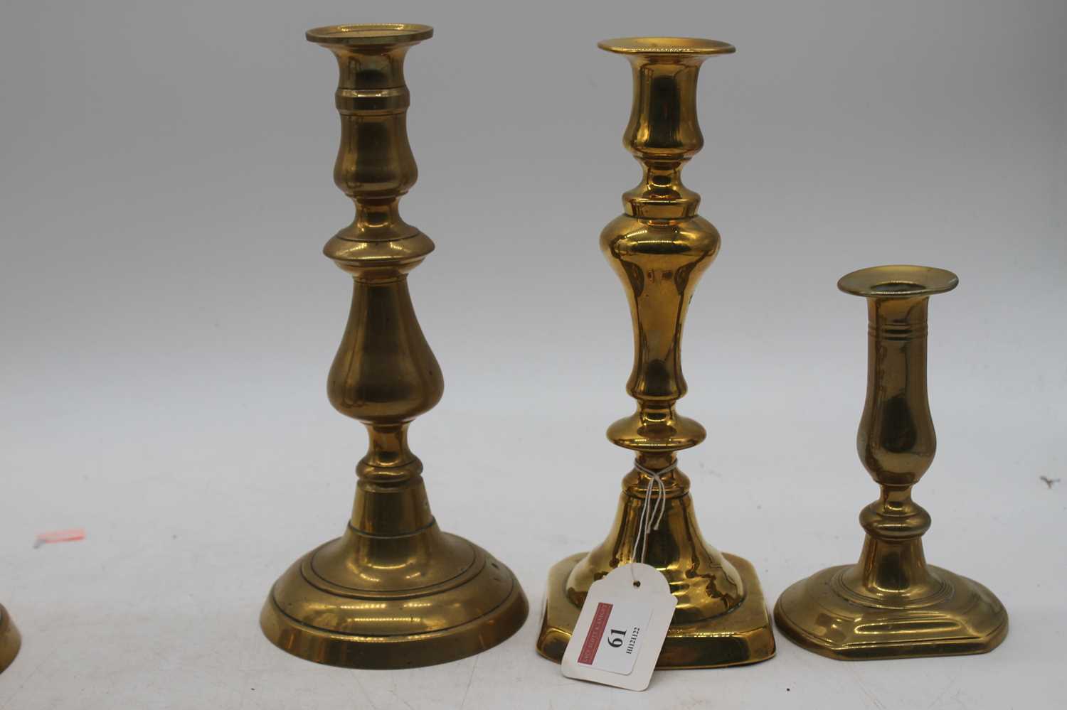 A pair of mid 19th century turned brass candlesticks with ejectors, height 24cm, together with two - Image 3 of 3