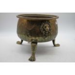 An early 19th century continental brass jardiniere of squat circular form having lion mask ring