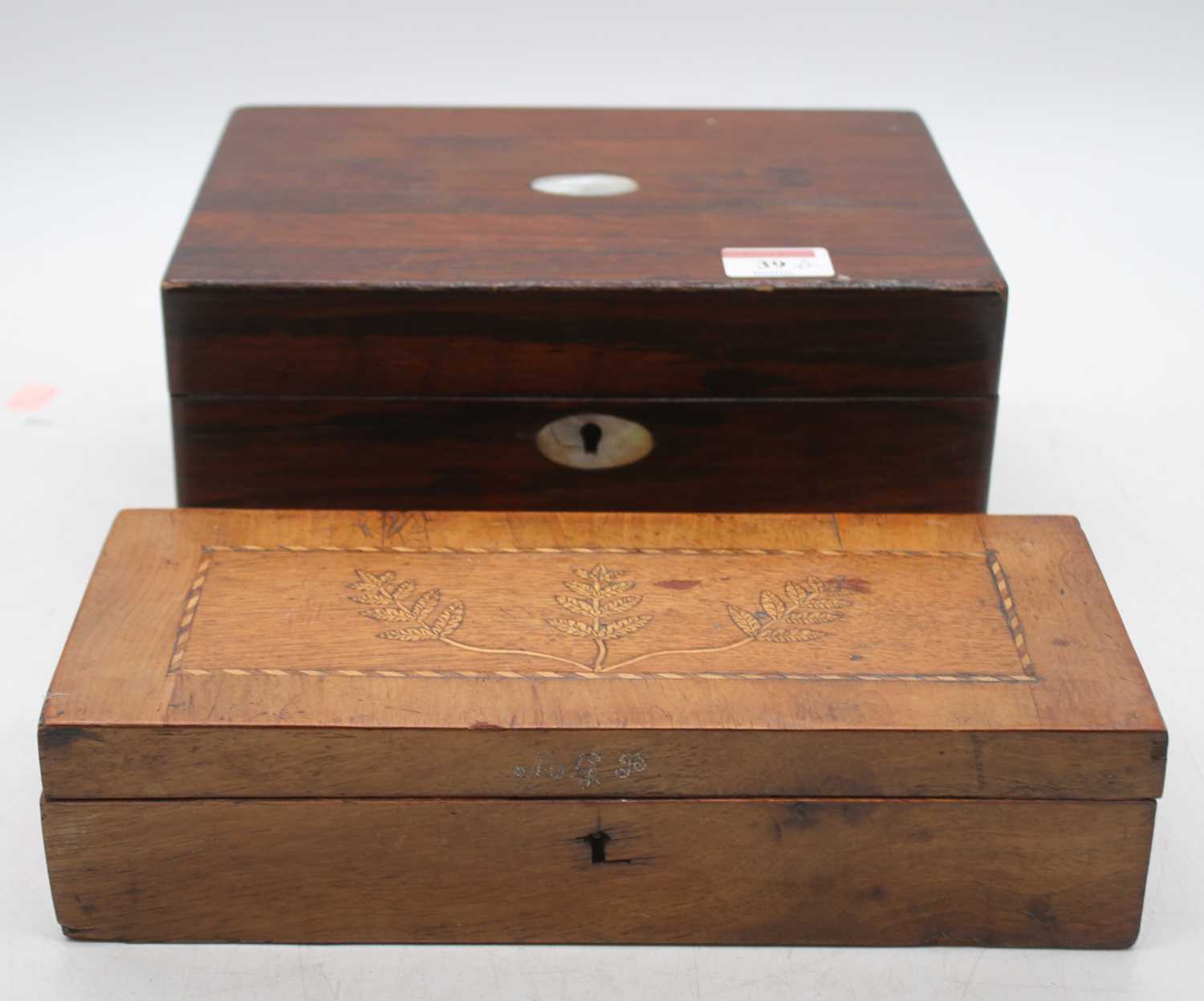 A Victorian rosewood and mother of pearl inlaid workbox having a partially fitted interior, width