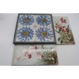 A pair of ceramic tiles, each of rectangular form and decorated with flowers, 30 x 15cm; together