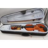 A modern Primavera Sound Lab UK student's violin with bow in travel case