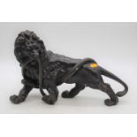 A Japanese Meiji period (1868-1912) bronze model of a lion and a snake, signed seal mark verso,
