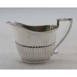 An Edward VII silver milk jug, of half-gadrooned form, Sheffield 1902, 5oz