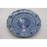 An 18th century Dutch Delft bowl of scalloped circular form, underglaze blue decorated with a bird