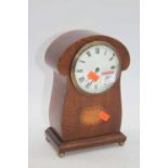 An Edwardian fiddleback mahogany and barber-pole strung mantel clock, the enamel dial showing