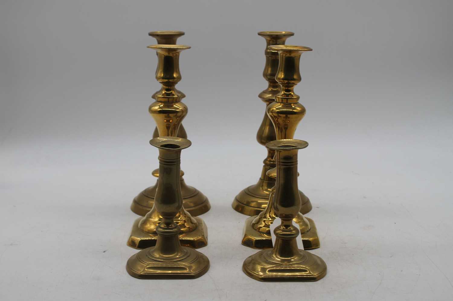 A pair of mid 19th century turned brass candlesticks with ejectors, height 24cm, together with two - Image 2 of 3