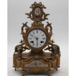 A late 19th century French gilt metal and porcelain inset mantel clock, having an enamel dial with