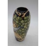 A Moorcroft pottery trial vase, of ovoid form, tube-line decorated with a vineyard scene, h.19cmNo