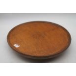 An Edwardian oak lazy Susan, having typical circular dished revolving top, dia. 40cmIn used