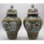 A pair of Chinese export vases and covers, each of baluster form, the bodies having opposing