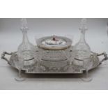 A Victorian style silver plated servery, having a central cut glass biscuit barrel with silver