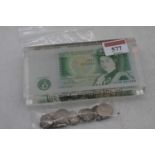 A one pound note set in clear resin; together with a collection of sixpences and threepenny bits